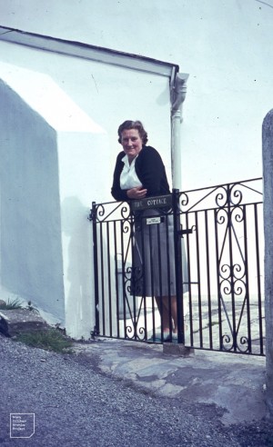Mary leaning on the gate to her cottage, May 1966.
