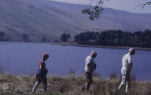 Jeremy, Jack Evans, Graham trudging alongside Upper Neuadd Reservoir to Taf Fechan source, 1971